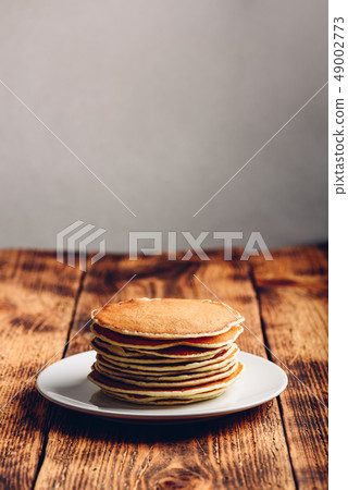 Stack of american pancakes on white plate 49002773