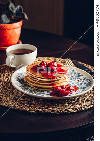 Stack of pancakes with cornelian cherry jam on 49002774
