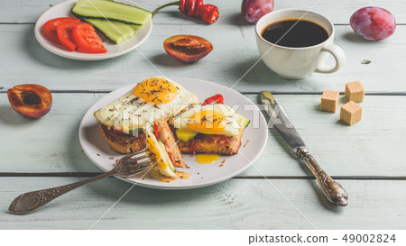 Sandwiches with vegetables and fried egg and cup 49002824