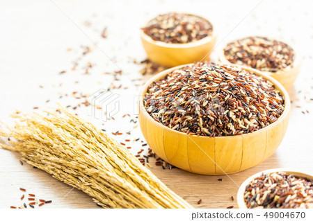 Raw rich brown in wooden bowl Raw rich brown in wooden bowl 49004670