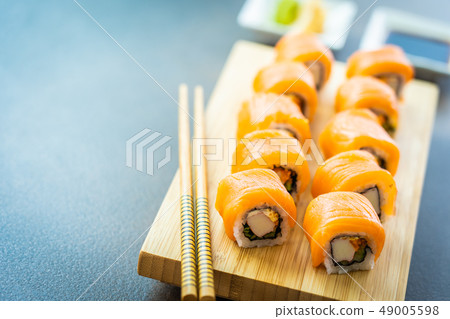 Salmon fish meat sushi roll maki on wood plate Salmon fish meat sushi roll maki on wood plate 49005598