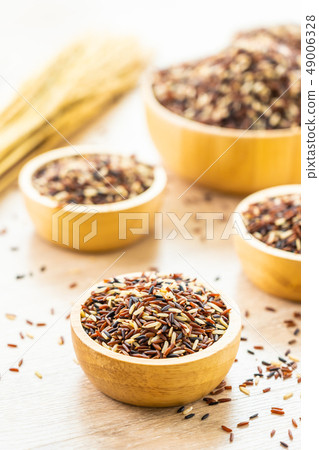 Raw rich brown in wooden bowl Raw rich brown in wooden bowl 49006328