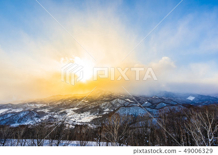 Beautiful landscape with mountain around tree in snow winter season at sunset time Beautiful landscape with mountain around tree in snow winter season at sunset time 49006329