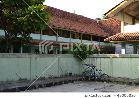A pedicab (known as "becak"), maybe not an 49006856