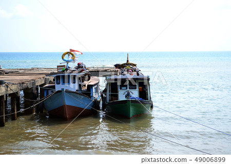 Two boats are parked and waiting at one dock 49006899