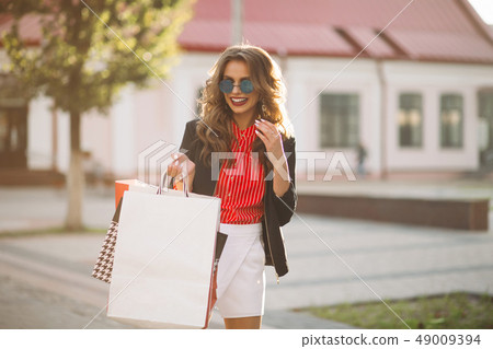 Fashionable brunette girl with colorful paper 49009394