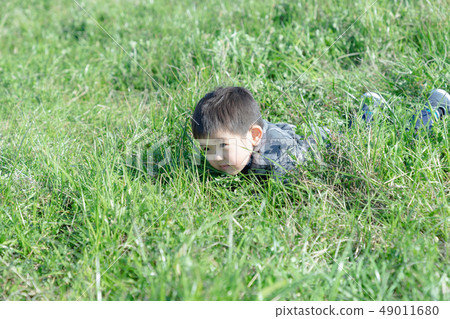Three-year-old child to confirm the feel of the grass 49011680