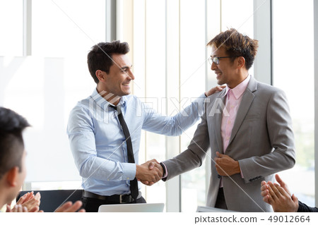 Handshake between the foreign CEO and staff 49012664