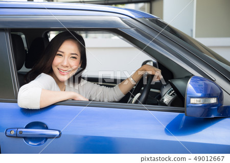Asian women driving a car and smile happily  49012667