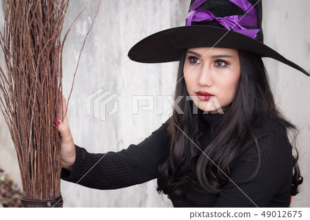 The witch and broomstick on dark background 49012675