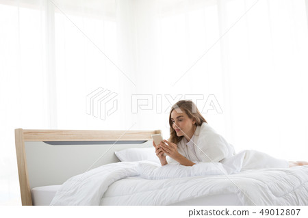 Relaxed caucasian woman using a smartphone 49012807