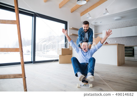 Two men having fun when furnishing new house, a new home concept. 49014682