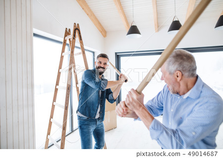 Two men having fun when furnishing new house, a new home concept. 49014687
