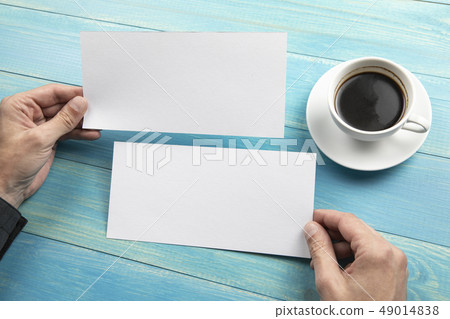 Mens hands holding white flyers Mens hands holding white flyers 49014838