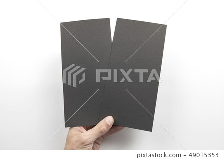 Mens hand holding black flyers Mens hand holding black flyers 49015353