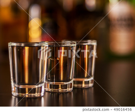 Traditional pure vodka in glasses on a black 49016456