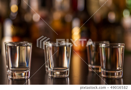 Traditional pure vodka in glasses on a black 49016582
