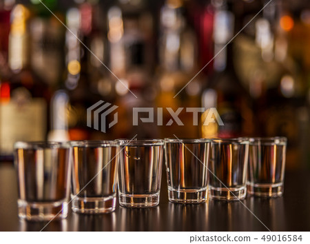 Traditional pure vodka in glasses on a black 49016584