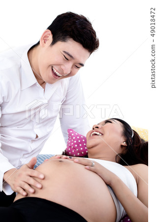 Smiling husband taking care of his pregnant wife 49018472