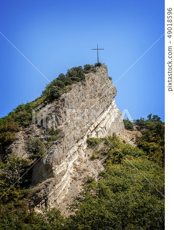 Cross mounted on a rock above the monastery. Cross mounted on a rock above the monastery. 49018596