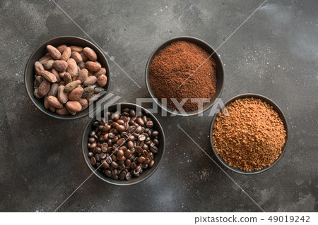 Concept of cocoa and coffee beans in bowls. 49019242