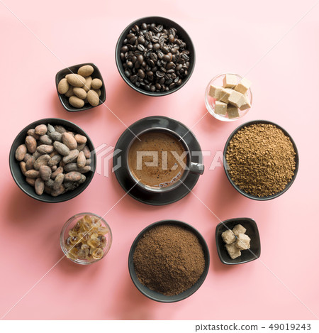 Concept of coffee, cacao beans and sugar on pink Concept of coffee, cacao beans and sugar on pink 49019243