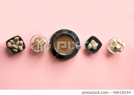Concept of coffee, cacao beans and sugar on pink Concept of coffee, cacao beans and sugar on pink 49019244