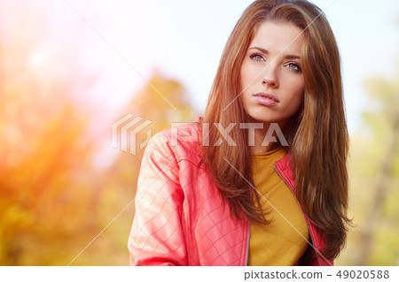 Fashion woman walking in autumn park Fashion woman walking in autumn park 49020588