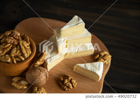 Cheese camembert or brie with walnut kernels Cheese camembert or brie with walnut kernels 49020732