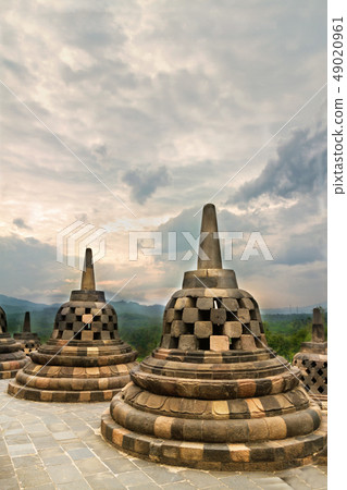 Ancient stupas in Borobudur Buddhist temple against dramatic sky 49020961