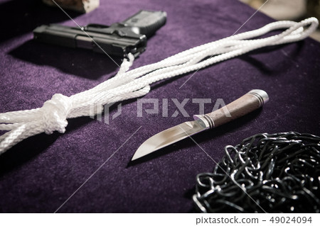 Pistol, knife, rope, chain, weapon on the table Pistol, knife, rope, chain, weapon on the table 49024094