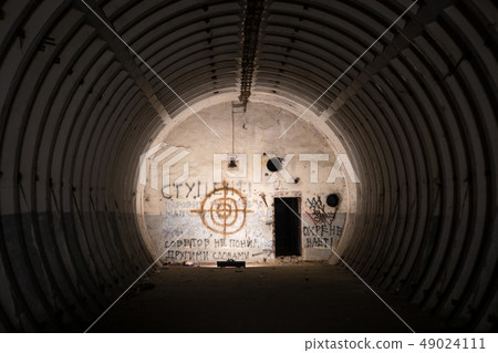 Abandoned ballistic missile bunker with graffiti and painted target 49024111
