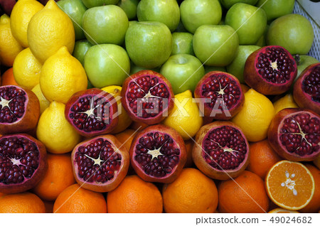 Pomegranates , lemons, oranges and apples at the Pomegranates , lemons, oranges and apples at the 49024682