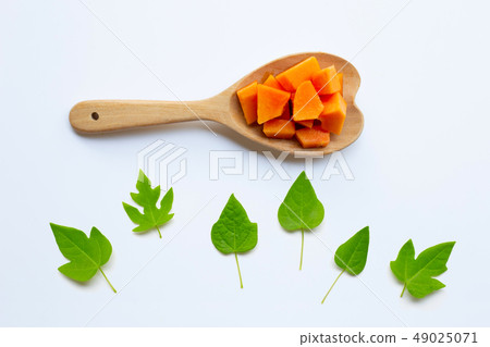 Papaya fruit with leaves on a white Papaya fruit with leaves on a white 49025071