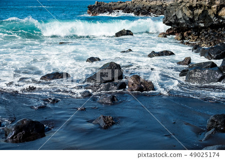 beautiful view on ocean water and black lava sand beautiful view on ocean water and black lava sand 49025174