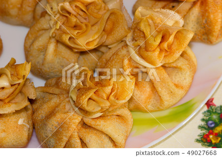 Pancake bags with filling on a plate Pancake bags with filling on a plate 49027668