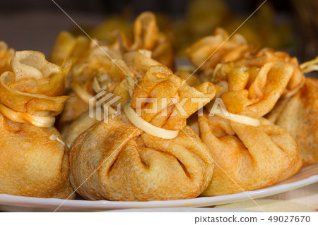 Pancake bags with filling on a plate Pancake bags with filling on a plate 49027670