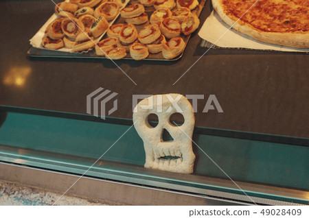 pizza in the form of funny skull to treat kids for Halloween party 49028409