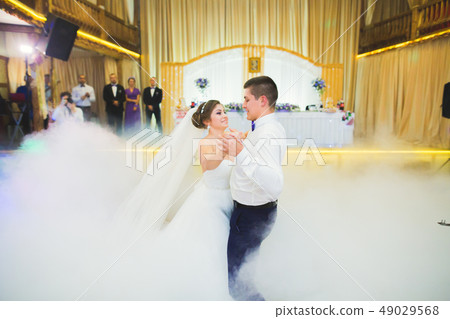 First wedding dance of newlywed couple in restaurant 49029568