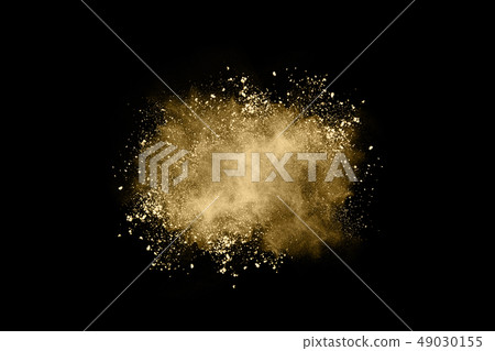 Golden powder explosion on black background. Golden powder explosion on black background. 49030155