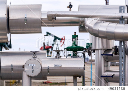 Green and red pumpjack, oil horse, oil derrick 49031586