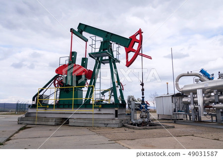 Green and red pumpjack, oil horse, oil derrick 49031587