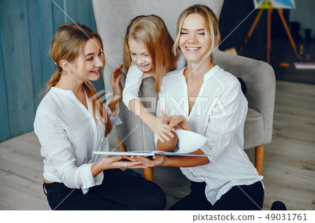 Mother reading a book with daughters Mother reading a book with daughters 49031761