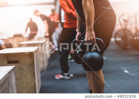 Man pulling kettlebells weights in the functional 49031939