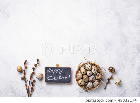 Easter background with quail eggs and pussy willow Easter background with quail eggs and pussy willow 49032174