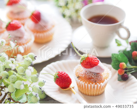 Tea time with strawberry cupcake 49033735