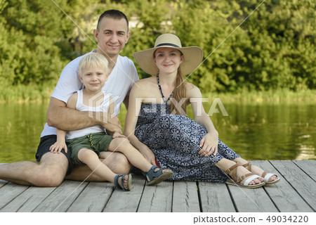 Happy young family, father mother and little blond 49034220