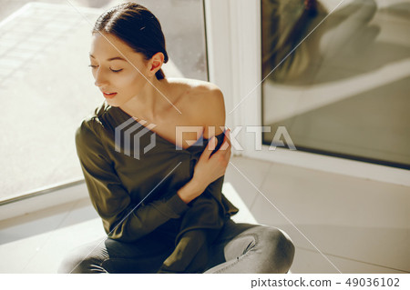 elegant girl in a green blouse elegant girl in a green blouse 49036102