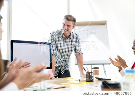 Successful casual businessman being congratulated 49037995