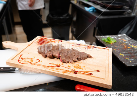Beef sliced for dinner on wooden chopping board Beef sliced for dinner on wooden chopping board 49038548